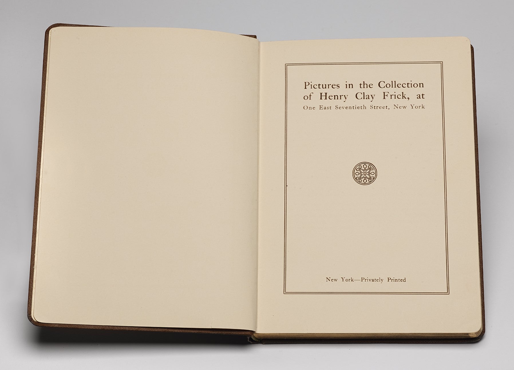 Book open to its title page at right