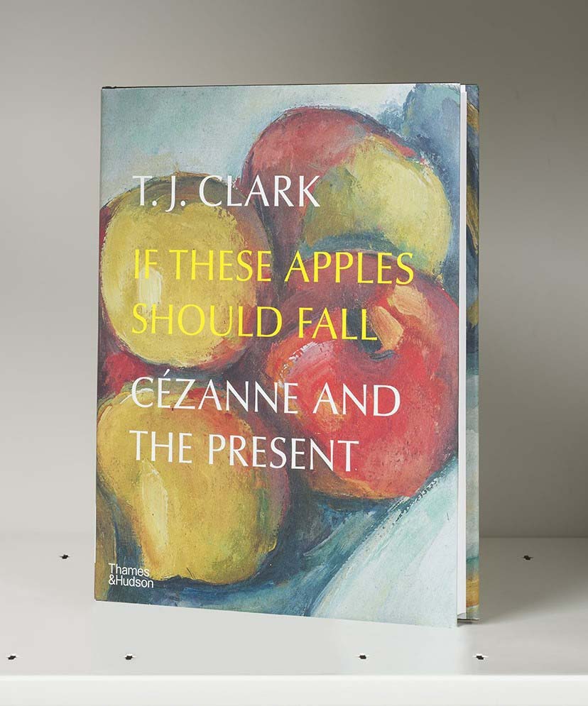 Book cover on a white shelf featuring painted red-and-yellow apples