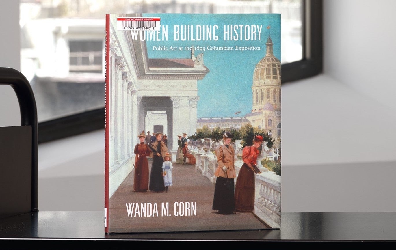 Book with an artwork detail of women on a terrace on its cover on a library cart in front of a window