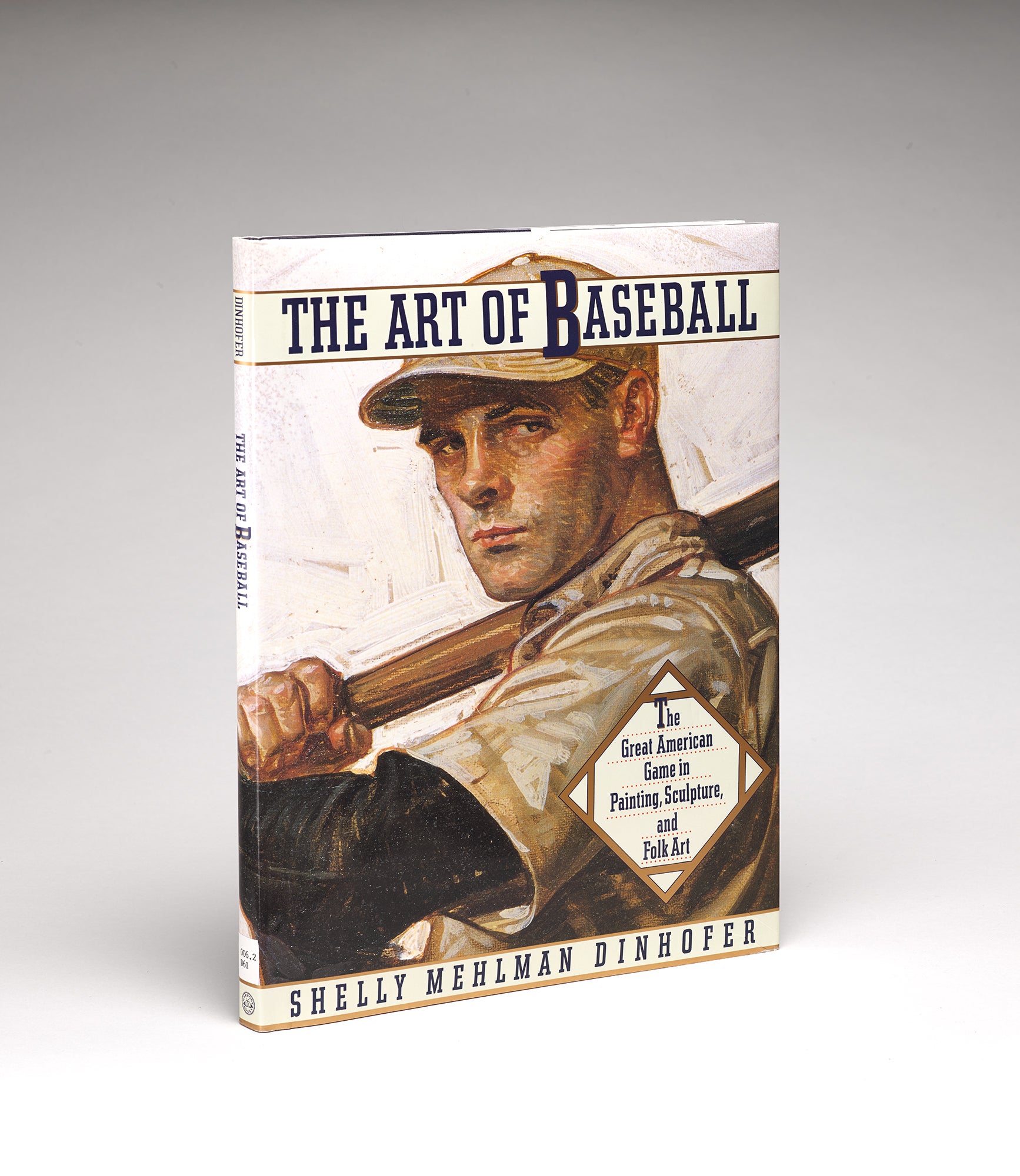 Cover of Shelly Mehlman Dinhofer's "The Art of Baseball," featuring a closeup detail of an artwork depicting a steely-eyed baseball player at bat in a white uniform