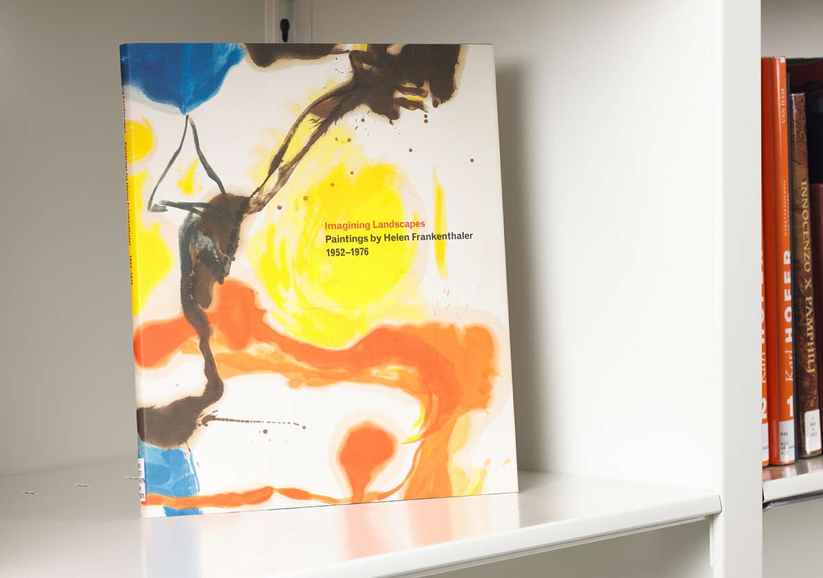 Book on a white shelf whose cover features a detail of a lyrical, colorful abstract painting
