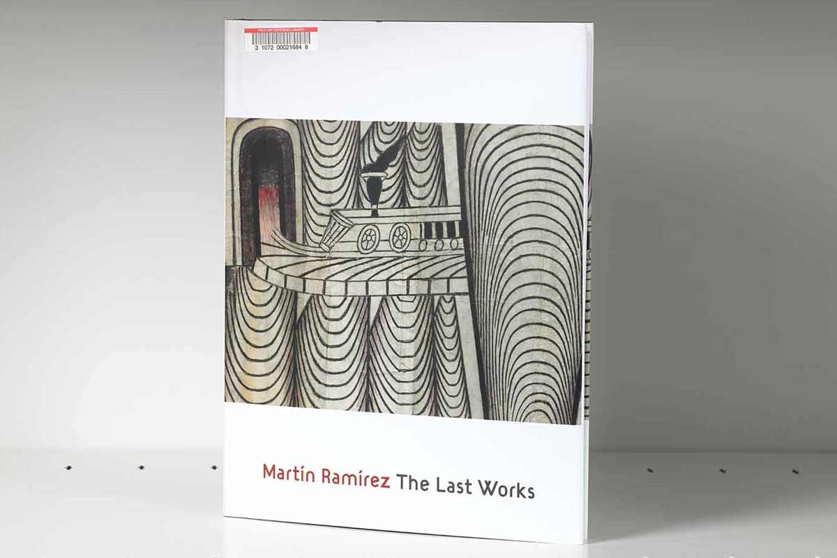 Book on a gray shelf whose cover features a geometric artwork detail