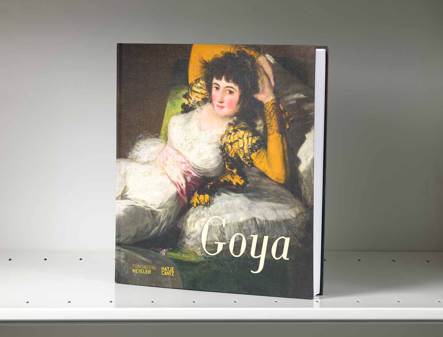 Book on a gray shelf whose cover features a painting detail of a reclining woman