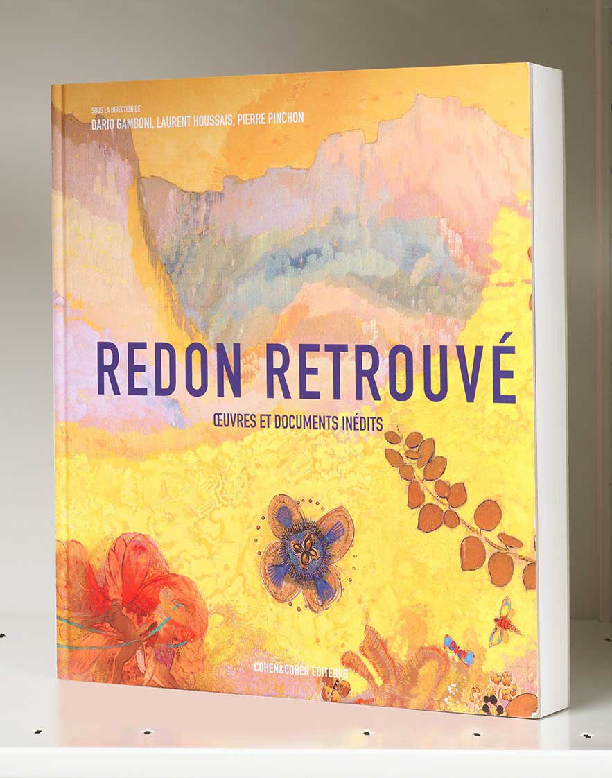 Book cover on a white shelf featuring a colorful yellow abstract landscape with floral motifs