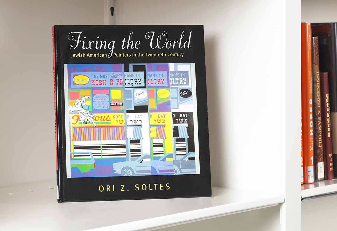 Book on a white shelf whose cover features an artistic depiction of the storefront of a Jewish eatery