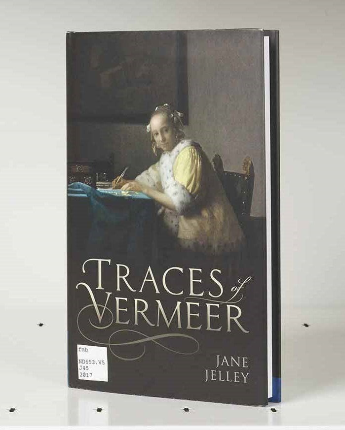 Book cover featuring a painting detail of an opulently dressed woman at a desk