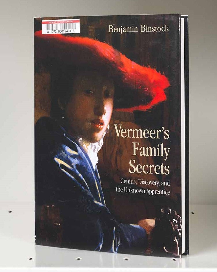 Book cover featuring a painting detail of a woman in a large red hat