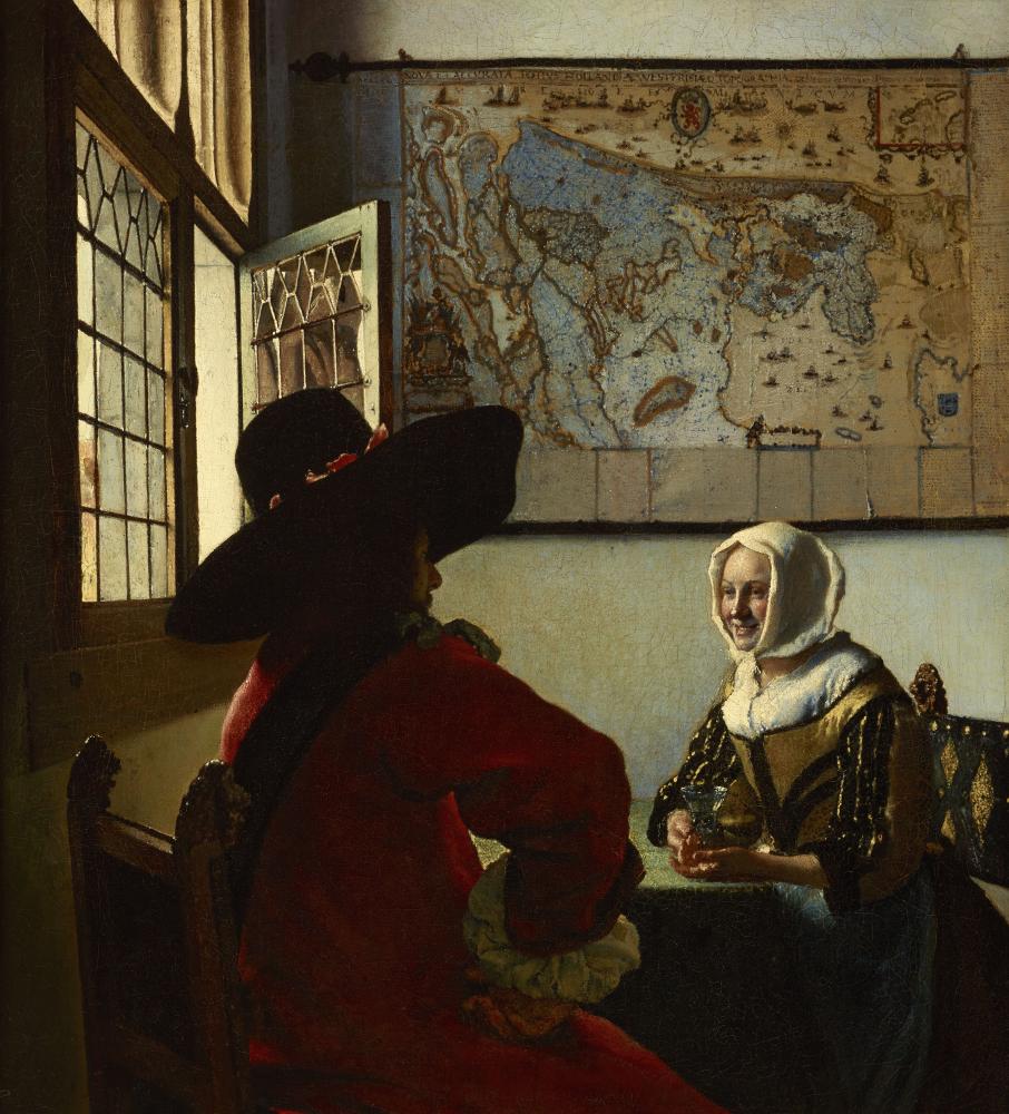 young woman and officer sitting at a table