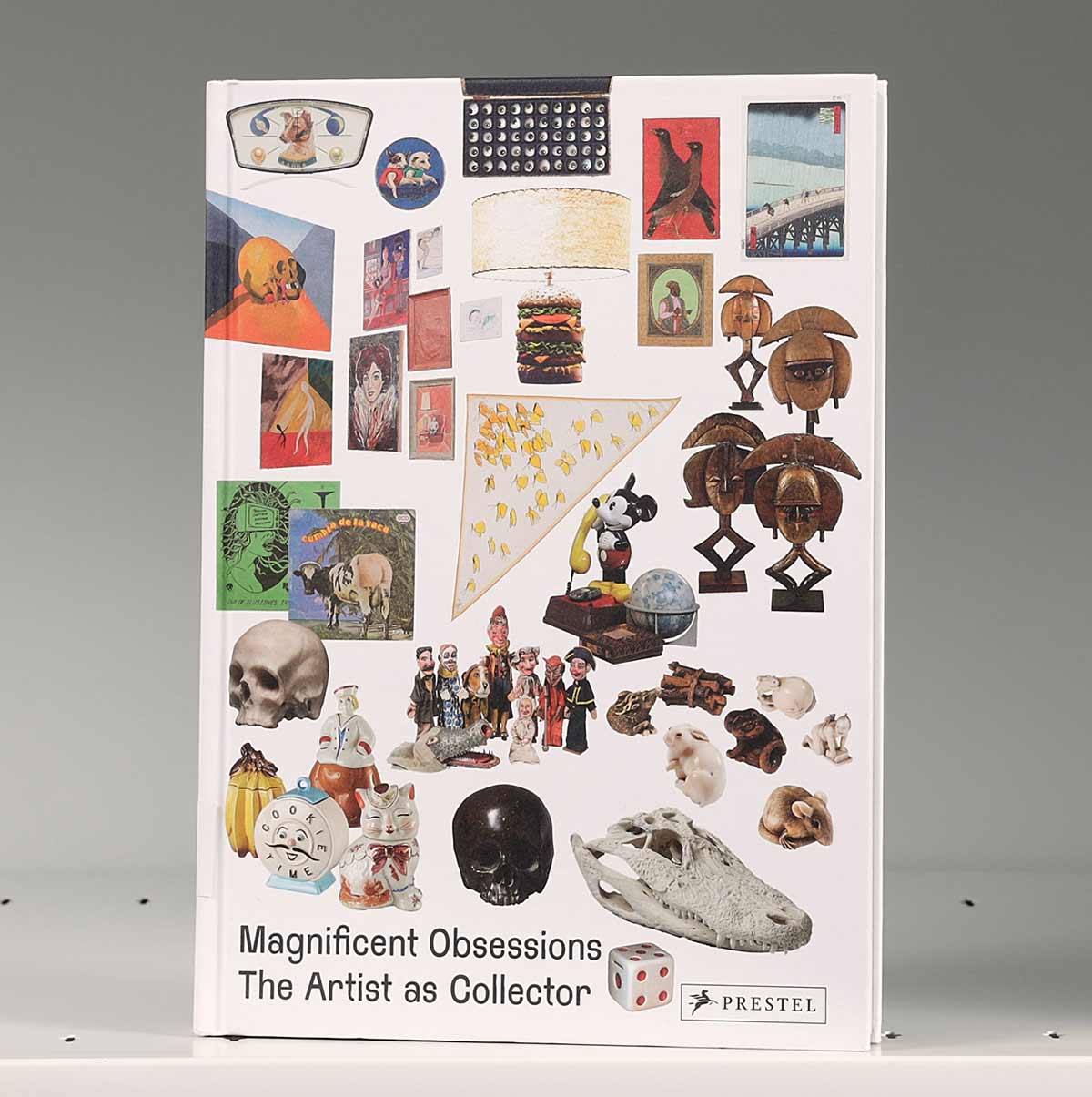 Book cover on a shelf featuring a collection of knickknacks and other small objects