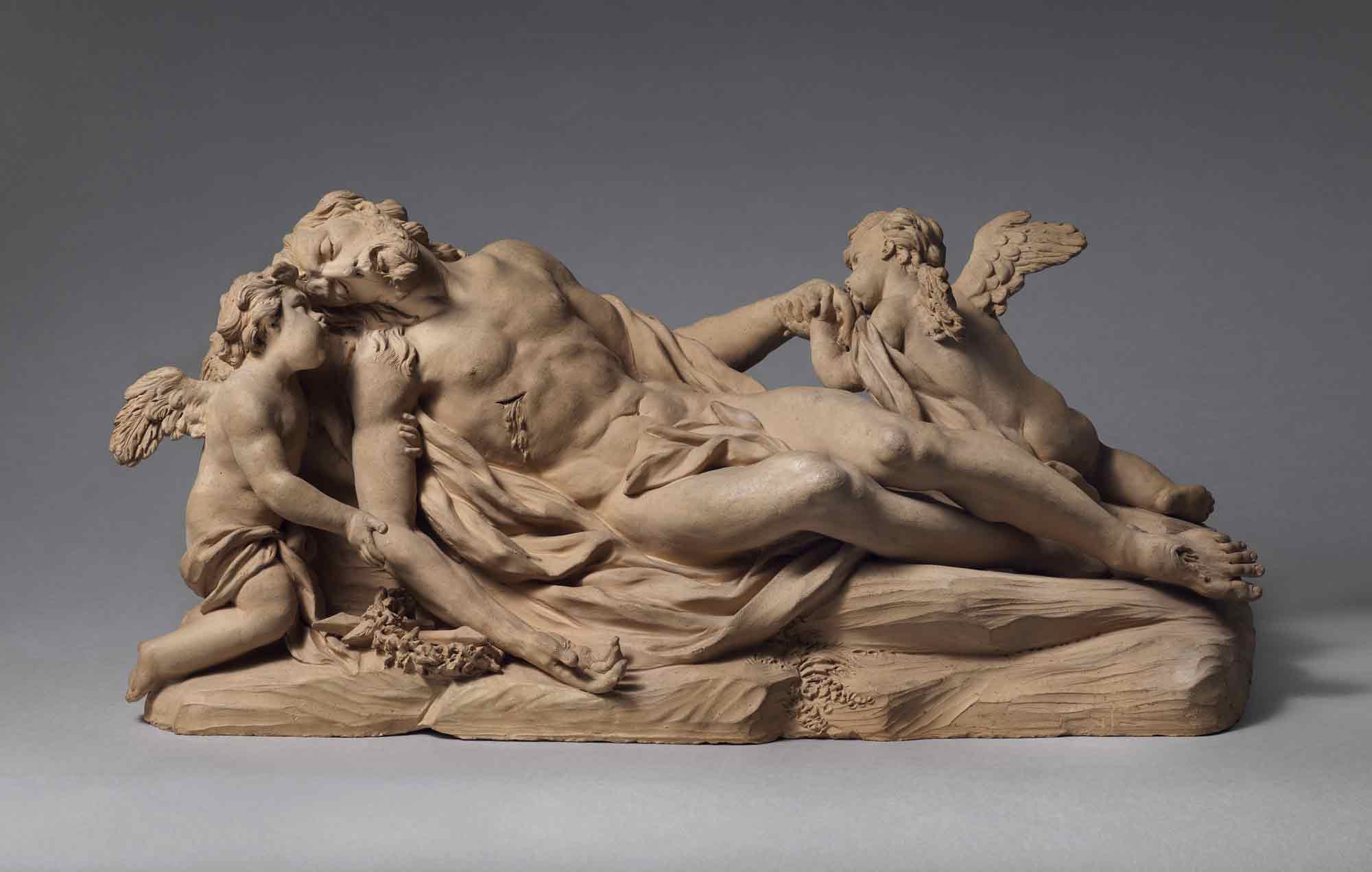 Terracotta sculpture of a dead reclining Jesus flanked by two mourning angels