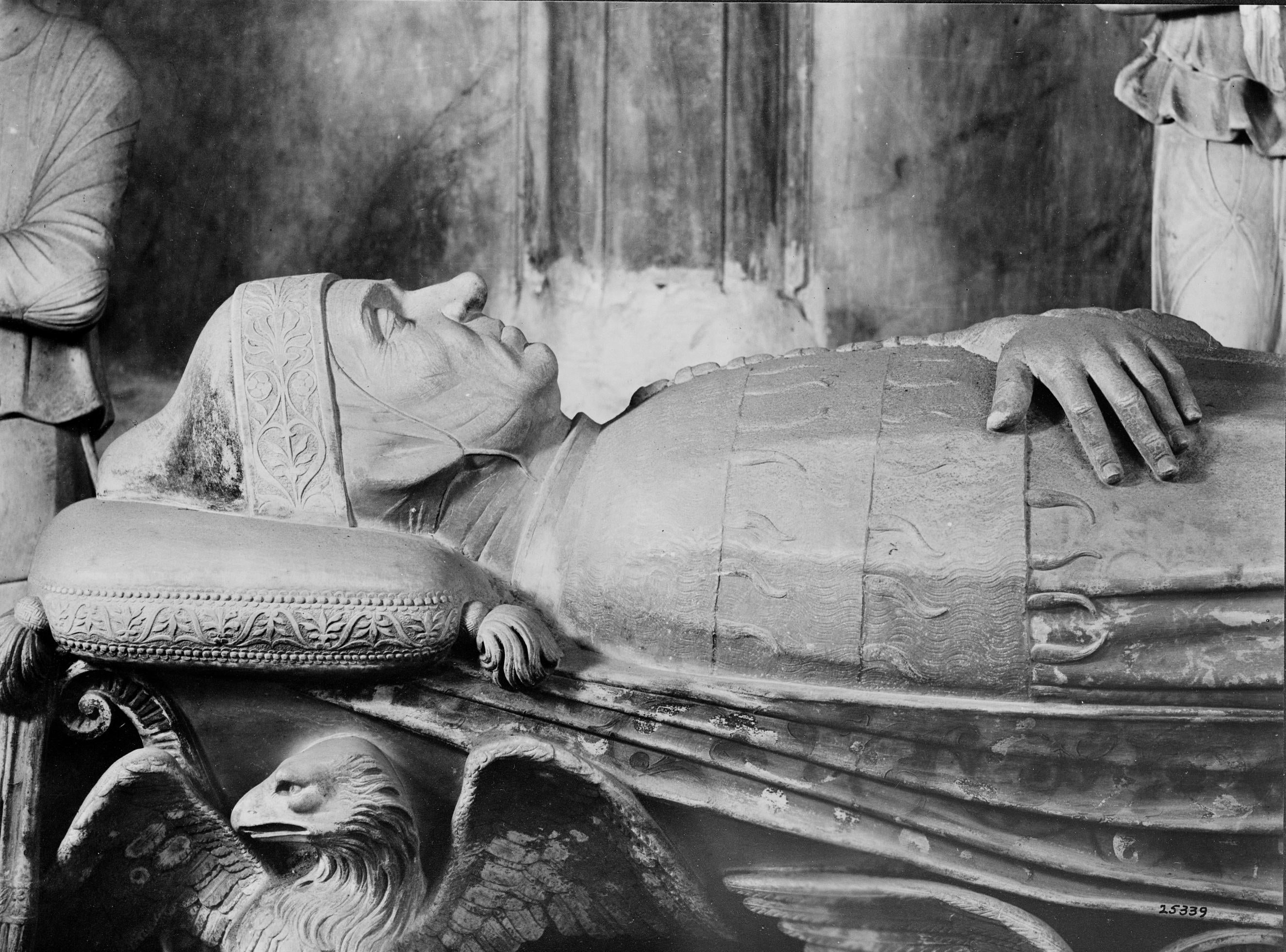 Detail of a photograph of a tomb monument showing a close-up of the effigy's head and shoulders.