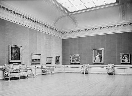 photo of Frick's east gallery with skylight, paintings, roped off chairs, circa 1935