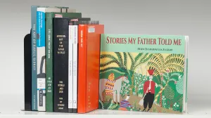 Book stack with one cover turned out with a colorful artwork of figures and a horse in a landscape