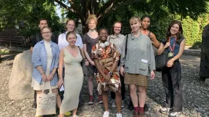 Group posing for a photo in a sculpture garden