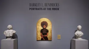 Arched gilded portrait of a woman with a large afro hairstyle between two marble busts