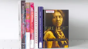 Stack of books with a featured cover showing a sepia photo of a Winnebago woman