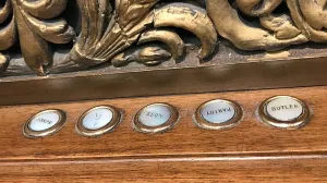 Five labeled buttons underneath decorative gold molding