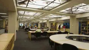 A view into a large study room featuring round tables and skylights.