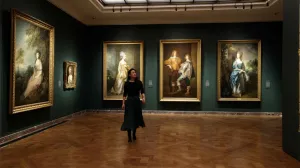 video still of woman in Frick gallery with paintings on the wall