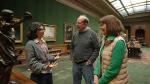educator talking to patrons in museum