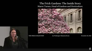 video still of person giving lecture with slide of tree in bloom