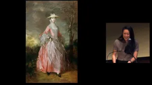 Aimee Ng giving presentation with painting of woman in pink dress projected on screen
