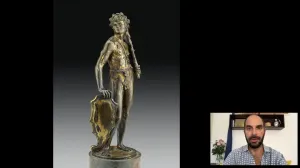 video still of Xavier Salomon and statuette