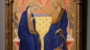 video still depicting biblical scene with Virgin Mary and Jesus Christ seated in blue robes