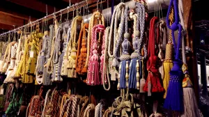 video still showing colorful assortment of passementerie, or tassels