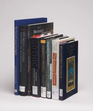 Stack of eight books with spines showing against a gray background