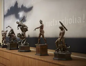 photo of statuettes on wood table 