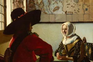 A man and a woman seated at a table by the window with a map on the wall