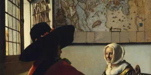 man and a woman seated in front of window