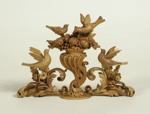 photograph of wood carving with birds, nuts, and berries.
