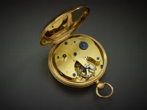 opened gold pocket watch showing inner workings