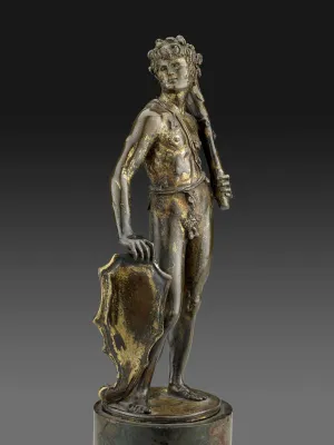 Bronze sculpture of a man standing upright.  His head is turned to his right and he is holding a club in his left hand.  A shield sits by his right leg and is underneath his right hand.