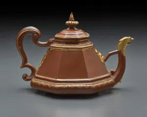 brown teapot in a pyramidal shape, with gold