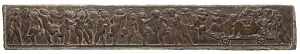 Bronze relief sculpture depicting a group of figures celebrating, dancing, and parading along a rectangular frieze.