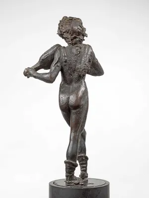 Bronze statuette seen from the back of a man playing an instrument that is propped on his shoulder.
