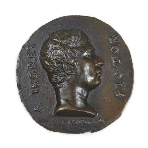 bronze profile of man atop rough circle of bronze with writing