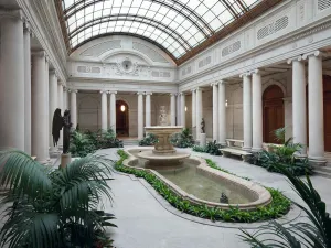 Garden court at The Frick Collection with fountain at center and skylight