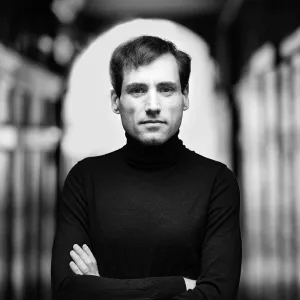 gray and white photo of man in archway