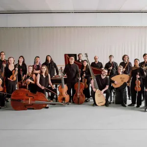 group of musicians seated and standed