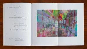 Book spread featuring a colorful, prismatic artwork of the interior of a building