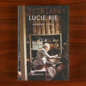 Book cover featuring a photo of an older woman potter in her studio