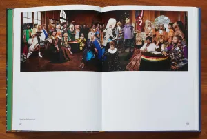 Book open to a spread with a photograph of Black models in a stylized re-creation of the signing of the Declaration of Independence