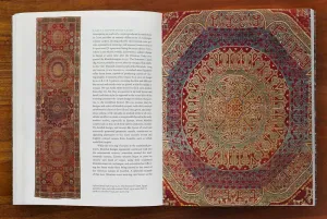 Book open to a spread with two images of vibrant Islamic carpets