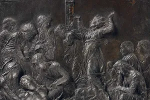 detail of bronze relief of figures mourning over body of Jesus Christ