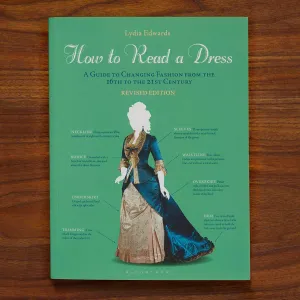 Book cover titled "How to Read a Dress" featuring a diagram of a gown