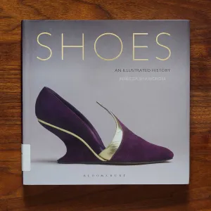 Book cover titled "Shoes" featuring an image of a sculptural purple-and-gold shoe